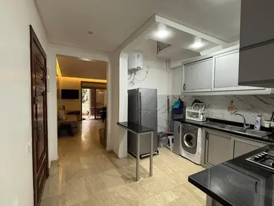 a kitchen with a refrigerator and a stove at Modern appt with pool and easy access to beach in Skhirat