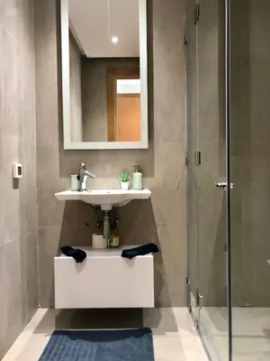 a bathroom with a sink and a shower at The Pearl - 3 Chambres Marina - By AppartAli in Casablanca