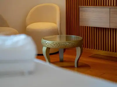 a coffee table and a chair in a living room at The Pearl - 3 Chambres Marina - By AppartAli in Casablanca