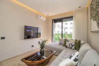 a living room with a couch and a table at 2 Bedroom Apartment City Center in Casablanca