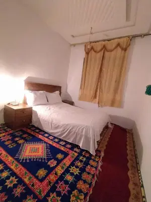 a bedroom with a bed and a rug on the floor at New Luxury Apart Victoria- Casablanca 2BR