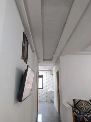 a room with a ceiling with a tv on a wall at New Luxury Apart Victoria- Casablanca 2BR