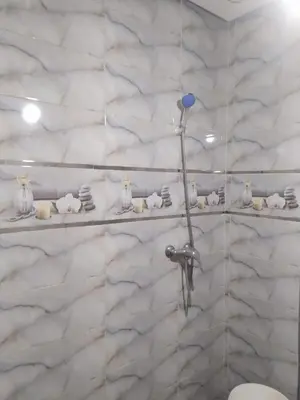 a bathroom with a white marble wall with shelves at New Luxury Apart Victoria- Casablanca 2BR