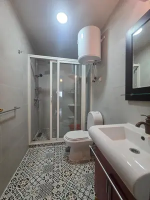 a bathroom with a shower and a toilet and a sink at Dar Tourabi in Casablanca