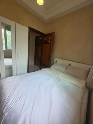 a bedroom with a large white bed with a mirror at Dar Tourabi in Casablanca