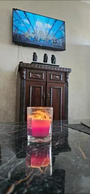 a candle on a table in front of a tv at Chic studio! Comfort and perfect location! in Rabat