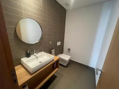 a bathroom with a sink and a mirror and a toilet at Nams Casa Home in Casablanca