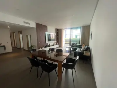 a living room with a wooden table and chairs at Nams Casa Home in Casablanca