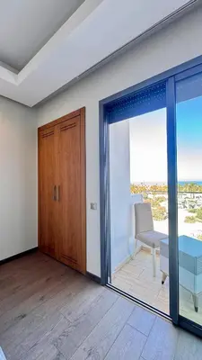 a living room with a table and a glass door at Family Trips or Professional Travels -By AppartAli in Casablanca