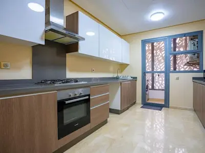 a large kitchen with a stove top oven in it at Family Trips or Professional Travels -By AppartAli in Casablanca