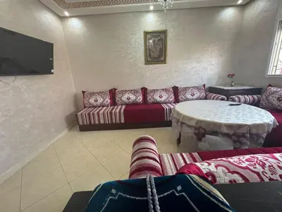 a living room with a couch and a table at Appatement authentique 7mn Hay Riad in Temara