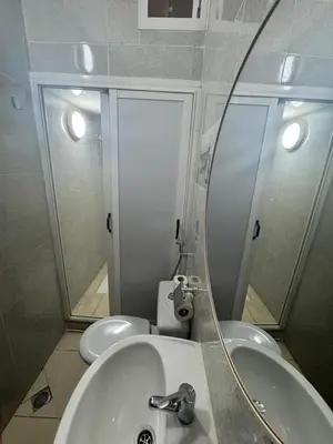 a bathroom with a sink and a toilet and a mirror at Appatement authentique 7mn Hay Riad in Temara