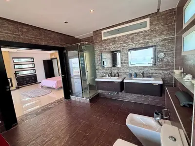 a bathroom with two sinks and a shower at Villa Miraluna ,Jacuzzi Retreat in Tamaris