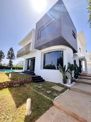 a large white house with a large window at Villa Miraluna ,Jacuzzi Retreat in Tamaris