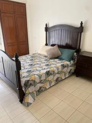 a bedroom with a large bed with a wooden headboard at Saad home in Casablanca