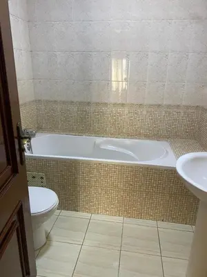 a bathroom with a tub and a toilet and a sink at Saad home in Casablanca