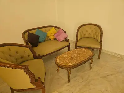a living room with two chairs and a couch and a table at Sables d'or flat apartement in El Harhoura