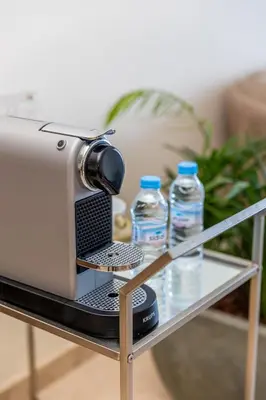 a camera on a table with water bottles on it at Homerest appartement Casablanca in Casablanca