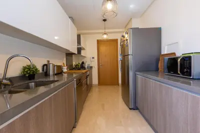 a kitchen with stainless steel appliances and a refrigerator at Homerest appartement Casablanca in Casablanca