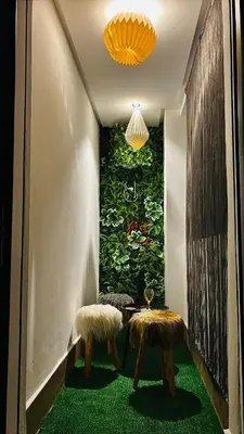 a room with two stools and a large painting at Terrace Solarium & Fitness & Berber Tradition in Casablanca
