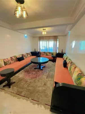 a living room with a large couch and a table at Paradise Casablanca in Casablanca