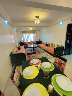 a living room with a table with plates on it at Paradise Casablanca in Casablanca