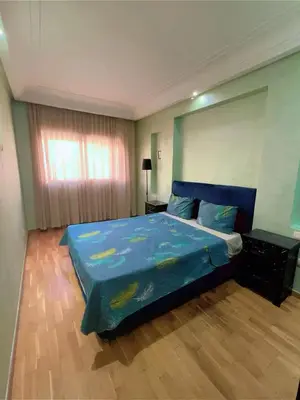 a bedroom with a bed with a blue comforter at Paradise Casablanca in Casablanca