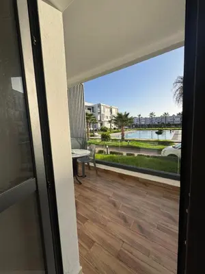 a view from the door of a balcony with a view of the water at Jolie appartement bord de mer de standing in Mohammedia