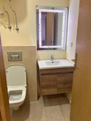 a bathroom with a toilet and a sink and a mirror at Charming Apartment Residence Ocean Park Pool, Sea in Aïn Harrouda