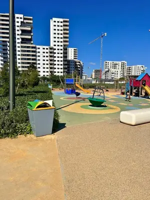 a park with a playground in a city with tall buildings at Charming Apartment Residence Ocean Park Pool, Sea in Aïn Harrouda