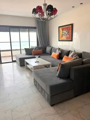 a living room with a couch and a table at Beautiful Apartment Residence Miramar Sea View in Mohammedia