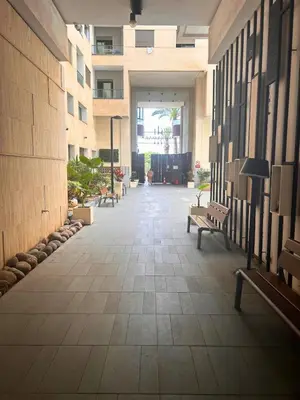 an empty hallway with benches in a building at Beautiful Apartment Residence Miramar Sea View in Mohammedia