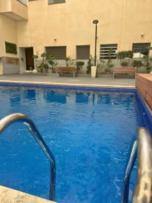 a large blue swimming pool in a building at Beautiful Apartment Residence Miramar Sea View in Mohammedia