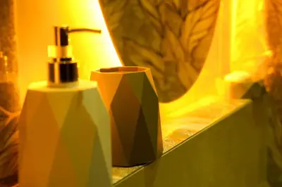 a bathroom with a bottle of soap and a mirror at Modern Apart Heart of Casablanca Perfect Location in Oulad Akkou