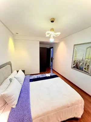 a bedroom with a large white bed in a room at Modern Apart Heart of Casablanca Perfect Location in Oulad Akkou