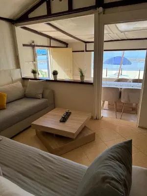 a living room with a couch and a coffee table at Joumaira beach in Temara