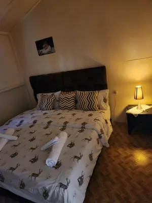 a bedroom with a bed with a bedspread with horses on it at Joumaira beach in Temara