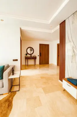 a living room with a couch and a table at Jolie appartement piscine bord de mer Haut standing in Mansouria