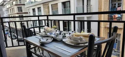 a table on a balcony with a plate of food at Le Casablanca in Maarif