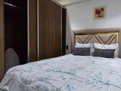 a bedroom with a large bed with a wooden headboard at Le Casablanca in Maarif