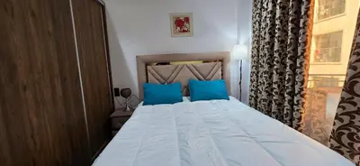 a bedroom with a large bed with blue pillows at Le Casablanca in Maarif