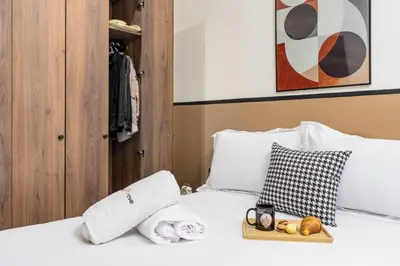 a bed with towels and a tray of food on it at The Nest Residence by GoodMove - Gauthier Casablanca in Casablanca