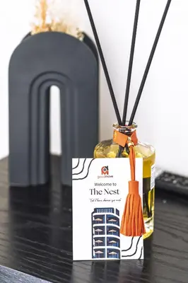 a bottle of the nest essential oils with an orange brush at The Nest Residence by GoodMove - Gauthier Casablanca in Casablanca