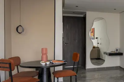 a room with a table and chairs and a mirror at The Nest Residence by GoodMove - Gauthier Casablanca in Casablanca