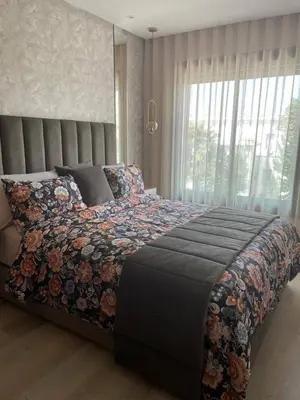a bedroom with a large bed with a large window at Studio de lux in Casablanca