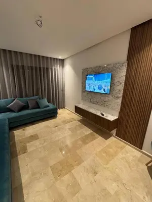 a living room with a couch and a flat screen tv at Studio de lux in Casablanca