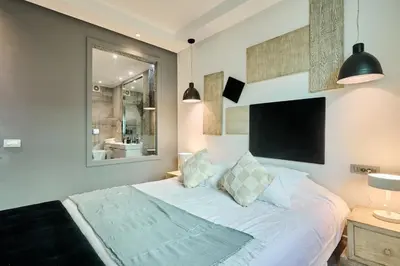a bedroom with a large white bed and a mirror at Gauthier Pearl - Luxury 3BR Apartment in Casablanca