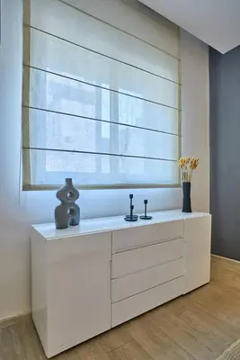 a white dresser in a room with a window at Gauthier Pearl - Luxury 3BR Apartment in Casablanca