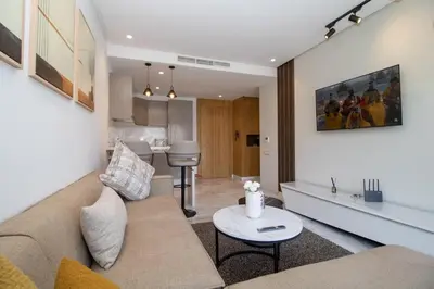 a living room with a couch and a table at Studio Palmier Casablanca in Maarif