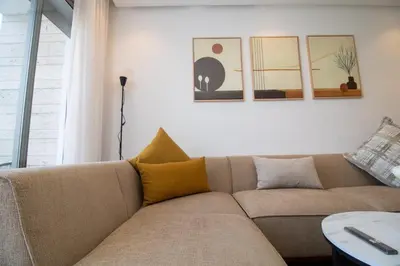 a living room with a couch and a table at Studio Palmier Casablanca in Maarif